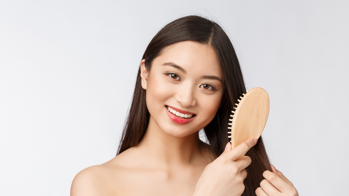 Asian American woman brushing hair