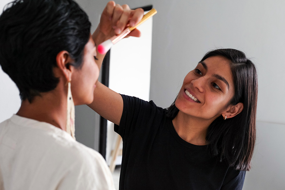 Latina makeup artist applying eyeshadow