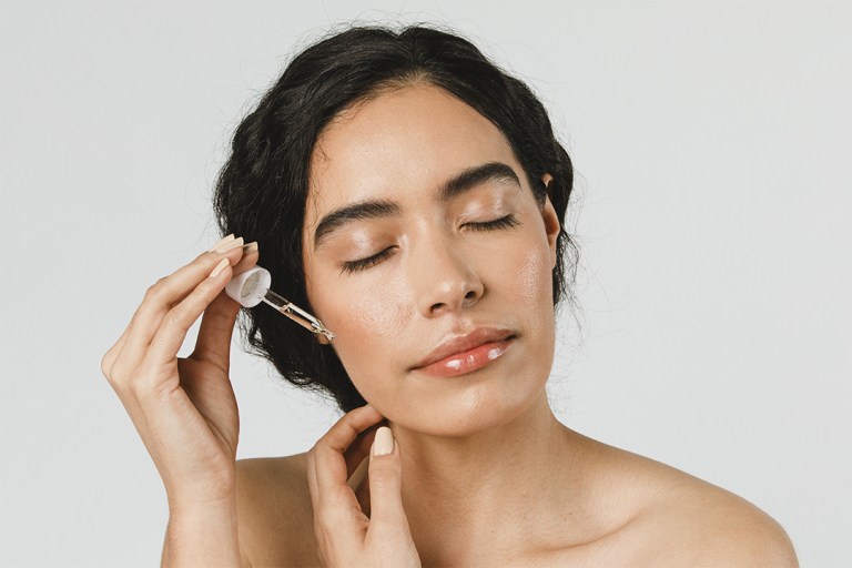 woman applying moisturizer